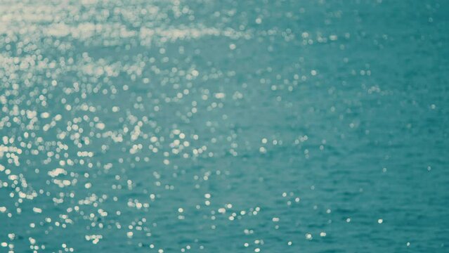 Abstract And Background Concept. Small Waves On Water Surface In Motion Blur With Bokeh Lights.