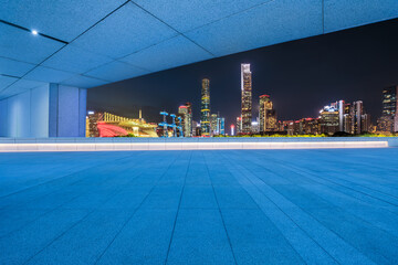 Empty square floor and bridge with modern city buildings at night in Guangzhou