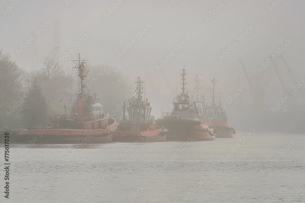 Wall mural The Port of Gdansk in the fog, tugs at the quay in the foreground. Baltic Sea, Gdansk, Poland