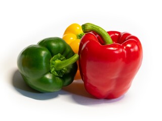 Red, green and yellow bell pepper on white background