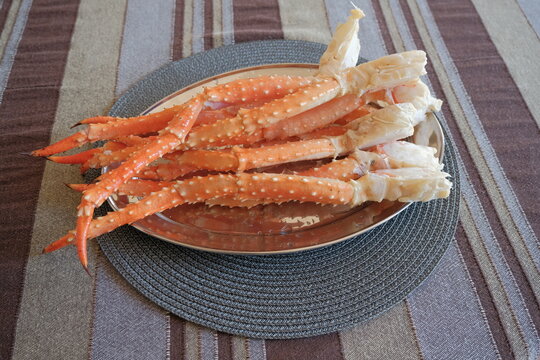 boiled frozen crab. red and white crab claws. king crab legs on a plate