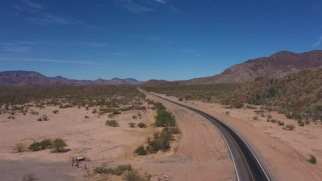 Flying over mexican road in desert. Highway in desert among rocky mountains