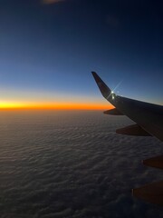 Fototapeta premium airplane in the sky at sunset