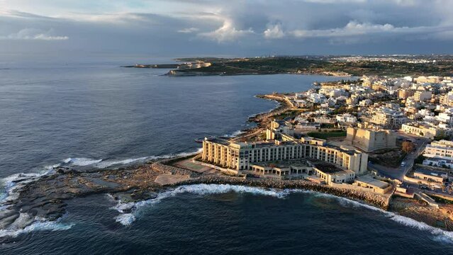 Aerial view of Abandoned Jerma Palace Hotel and l-Jerma Bay in Marsaskala, sunrise time, Malta.