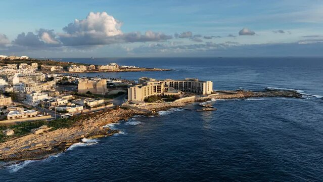 Aerial view of l-Jerma Bay and Abandoned Jerma Palace Hotel in Marsaskala, sunrise time, Malta.