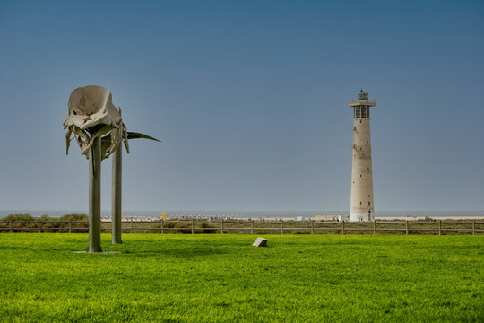 Morro Jable lighthouse and the whale skeleton on the island of Fuerteventura in the Canary Islands.