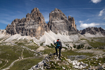 Stunning view of a tourist enjoying the view of the Tre Cime Di Lavaredo, Dolomites, Italy. - 775642468