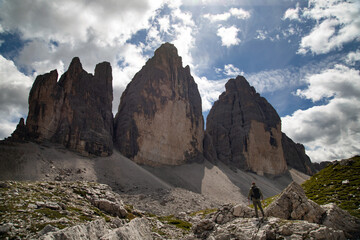 Stunning view of a tourist enjoying the view of the Tre Cime Di Lavaredo, Dolomites, Italy. - 775642827