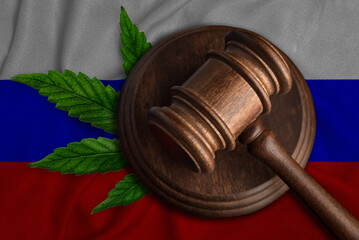 Judges gavel and cannabis leaf on the flag of Russia. The concept of legalization of marijuana in Russia.