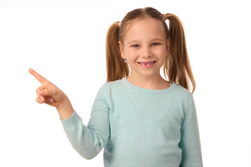 Adorable little girl pointing her index finger on white background