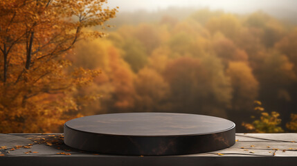 Empty round black stone podium for product display with blurred autumn forest background. Rock cylinder shape for brand promotion.