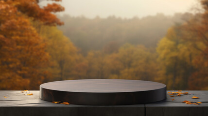 Empty round black stone podium for product display with blurred autumn forest background. Rock cylinder shape for brand promotion.