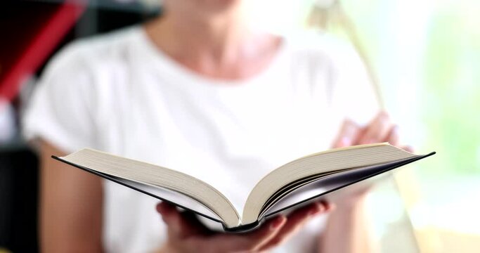 Woman hands leaf through book reading pages. Religion wisdom concept of reading and imagination