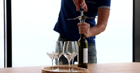 Alcohol etiquette and opening of elite wine with corkscrew. Sommelier courses for beginners and selection of quality elite white wines