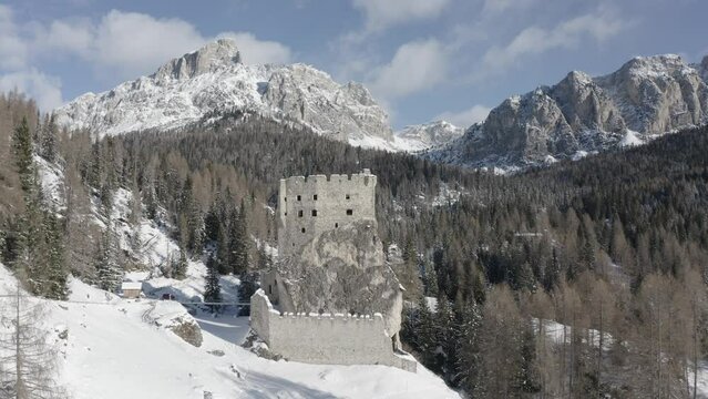 Breathtaking aerial views of Andraz castle ruins in Picturesque Dolomite mountains forests