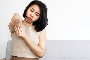 Asian woman having problem with skin condition dark elbow