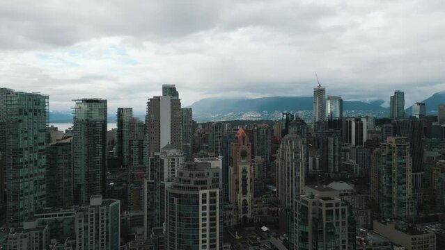 aerial view over vancouver city revealing the skyline and the mountain behind on an overcast day, British Columbia, Canada