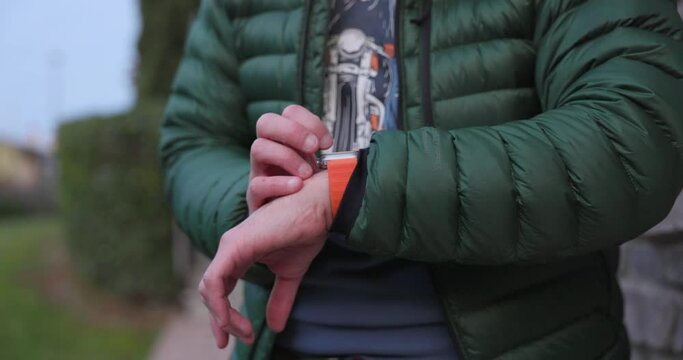 A Man Utilizing the Features of the Apple Watch Ultra 2 on His Wrist - Close Up