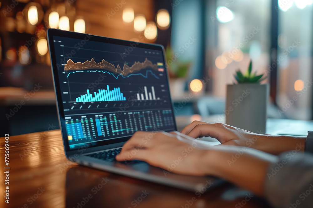 Poster a person reviewing their investment portfolio on a laptop computer. person typing on laptop with gra