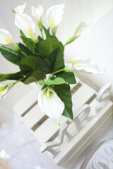 Minimalist Malay wedding stage decorations with flowers and leaf.