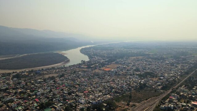 Drone shot of Rishikesh City. Aerial view of the beautiful holy river Ganga, Lakshman Jhula bridge, and Tera Manzil Temple, Trimbakeshwar in Rishikesh. Holy town and travel destination in India.