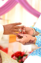 Malay marriage, malay wedding ceremony, exchange of rings close-up. Selective focus.
