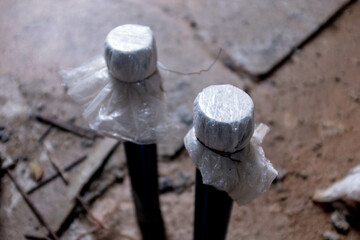 White PVC pipes protruding out of a floor in a construction project