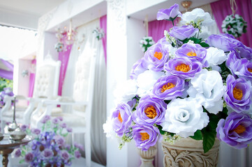 Malay wedding decor stage with flowers and chair. Wedding setup.