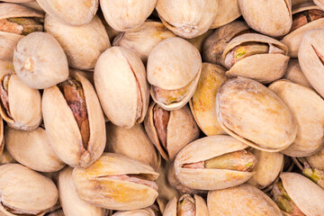 Background of the roasted salted pistachio nuts close-up