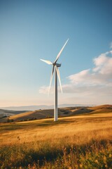A wind turbine stands tall in a vast field, harnessing wind energy to generate power for nearby areas. The turbine blades rotate steadily against the sky backdrop