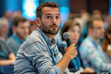 Focused male conference attendee asks a question during a presentation