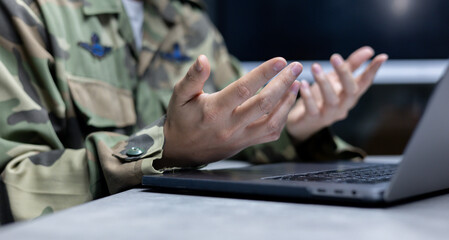 close up operator solider man hand try to explain about security system of mission to team by...