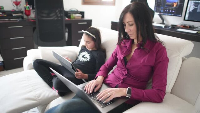 Mother and daughter working from home