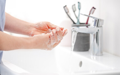 Girl Washes Hands With Liquid Soap In Pristine Bathtub