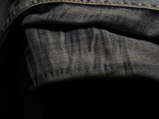 Old jeans texture in the dark for a cool background.