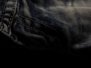 Old jeans texture in the dark for a cool background.