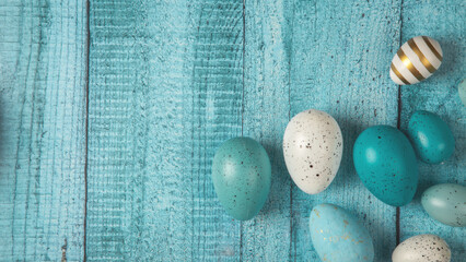 Multicolored easter eggs on blue wooden background. Happy Easter! Copy space