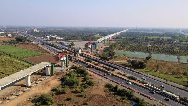 Aerial View: Mumbai to Ahmedabad Bullet Train Bridge Construction Over Surat Mumbai Highway. India's biggest project of HSRC bullet train under construction. Developing India concept.