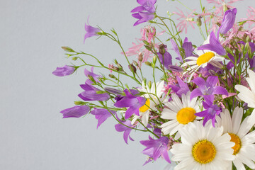 Bouquet of wildflowers on a blue background

