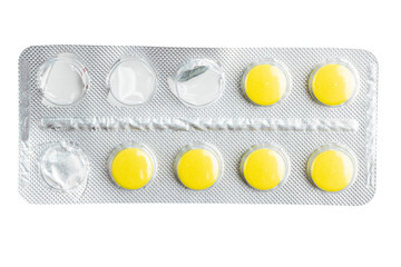 Yellow medicine pills in a blister pack isolated on white background, healthcare and medicine...