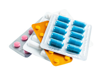 Various medicine capsules, pills and tablets in a blister pack isolated on white background,...