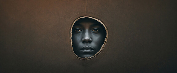 A face peeks through a hole in a dark brown wall, panorama, banner with copy space for text