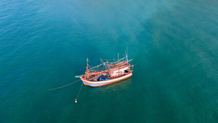 Fishing boat in the ocean for catching fish all a long night - at Thailand. Top view of Fishing Boat running verry fast on the sea to port