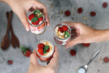 Top View of Three Jars Fresh Dessert of Parfait Served on Gray Background 