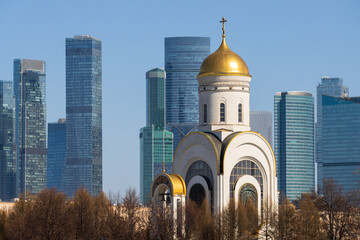 View of the church and skyscrapers. Modern city landscape. A beautiful church against the backdrop of high-rise buildings. Moscow, Russia. In the distance is the Moscow international business center.