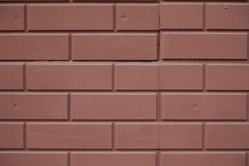 Close shot of reddish brown painted brick veneer wall