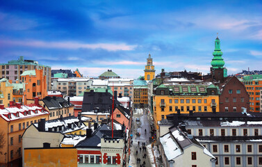 Beautiful cityscape - City museum, Church, traditional houses covered with snow and people go...
