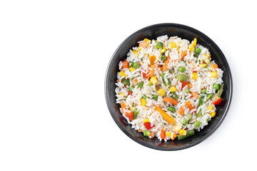 White rice with vegetables in a black bowl isolated on white background. Top view. Copy space