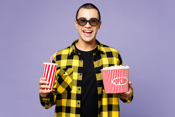 Young smiling fun middle eastern man wear yellow shirt casual clothes 3d glasses watch movie film...