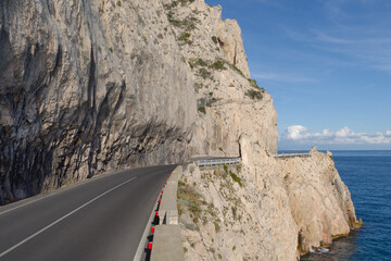 Coastal road winding along a cliff - 775739686